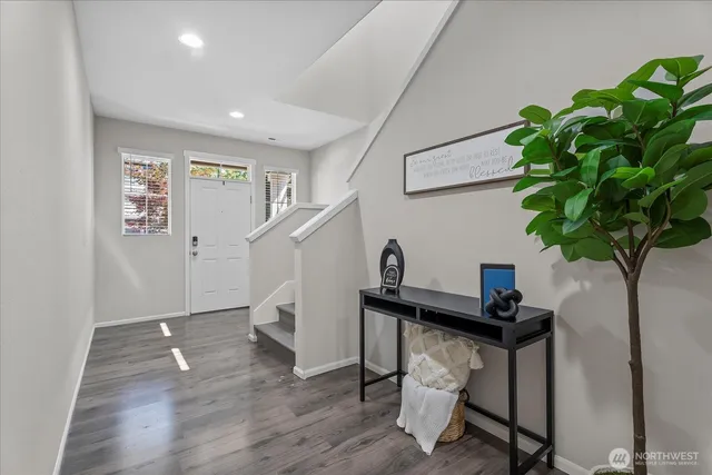 a view of entryway with wooden floor and stairs