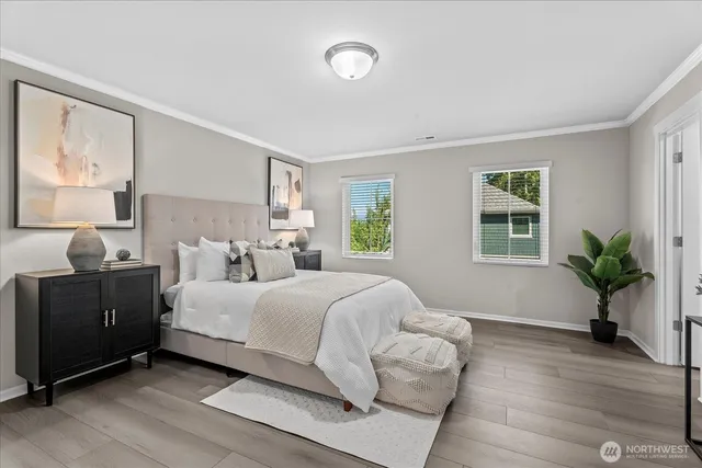 a bedroom with a bed and a potted plant
