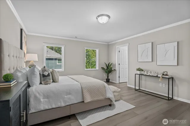 a bedroom with a large bed and paintings on the wall