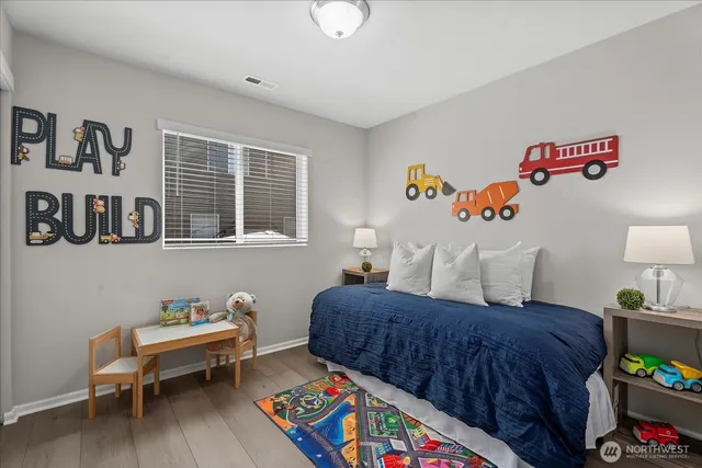 a bedroom with furniture and a wooden floor