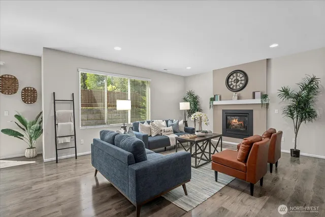 a living room with furniture a large window and a fireplace