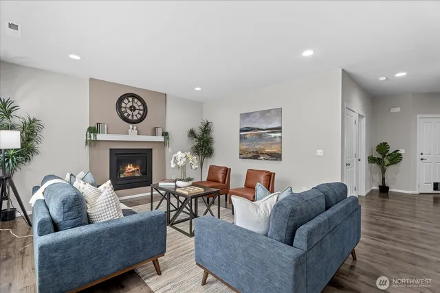 a living room with furniture and a fireplace