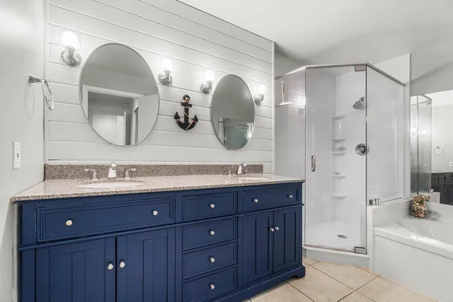 a bathroom with a double vanity sink and a mirror