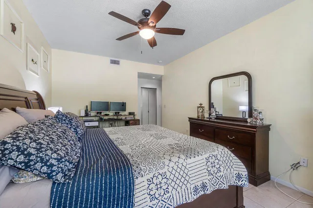 a bedroom with a bed and dresser with mirror