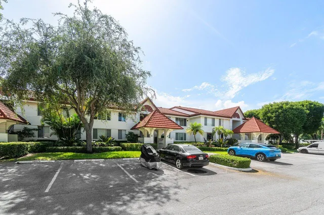 a view of house with outdoor space and parking