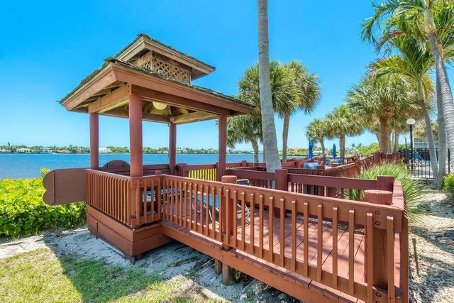a view of a chair and tables under an umbrella
