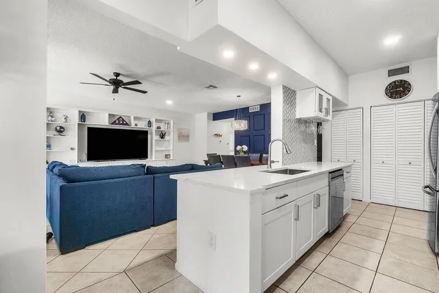 a large kitchen with cabinets and stainless steel appliances