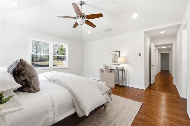 a bedroom with a bed and wooden floor