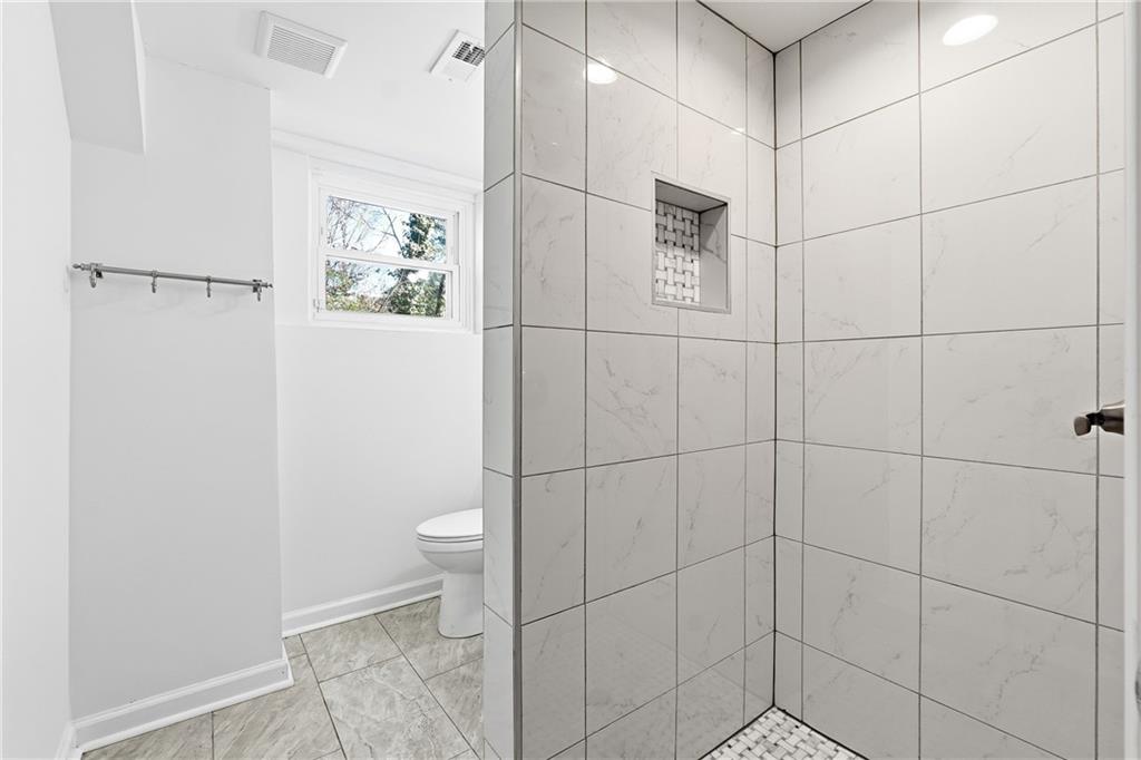 2629 Henderson Road Tucker, GA 30084 - Photo 22 of 31 a bathroom with a toilet and a shower