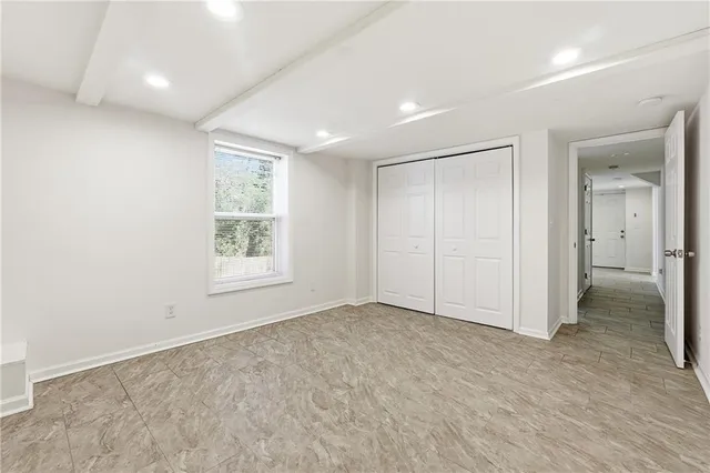 an empty room with windows and closet