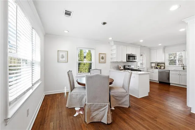 a view of a dining room with furniture and wooden floor