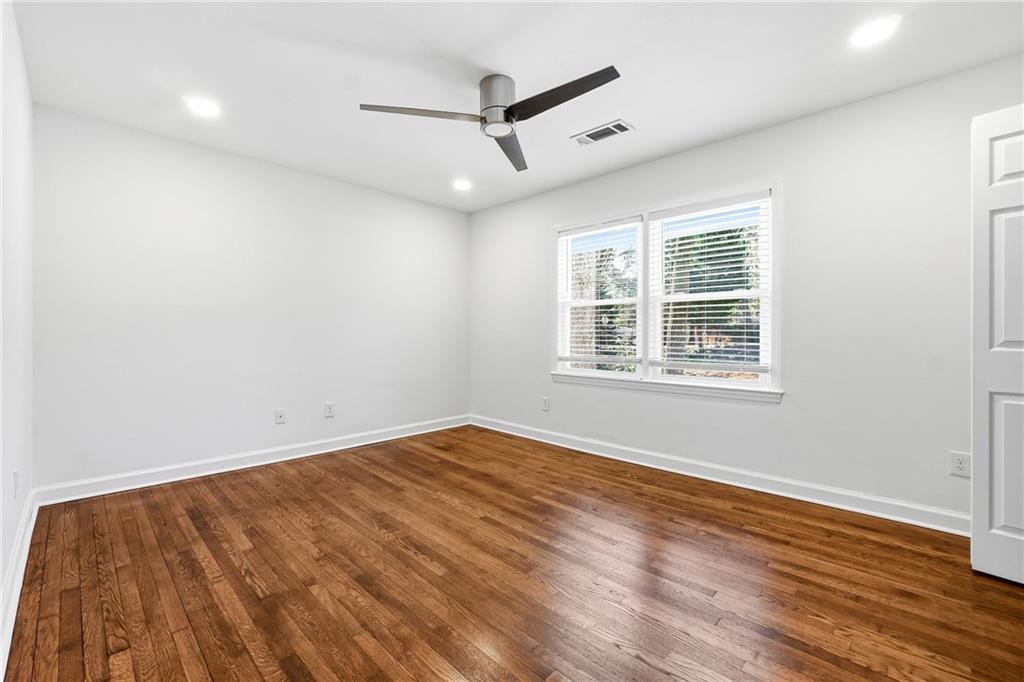 2629 Henderson Road Tucker, GA 30084 - Photo 10 of 31 wooden floor in an empty room with a window