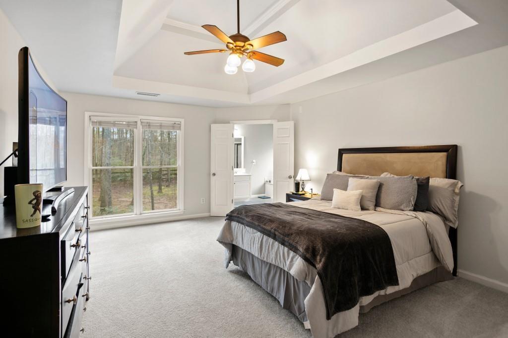 541 Battleview Drive Smyrna, GA 30082 - Photo 14 of 25 a spacious bedroom with a bed a chandelier and a large window
