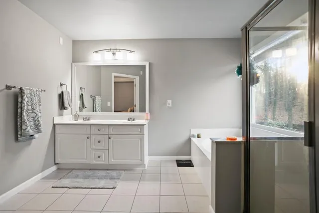 a spacious bathroom with a double vanity sink and a mirror