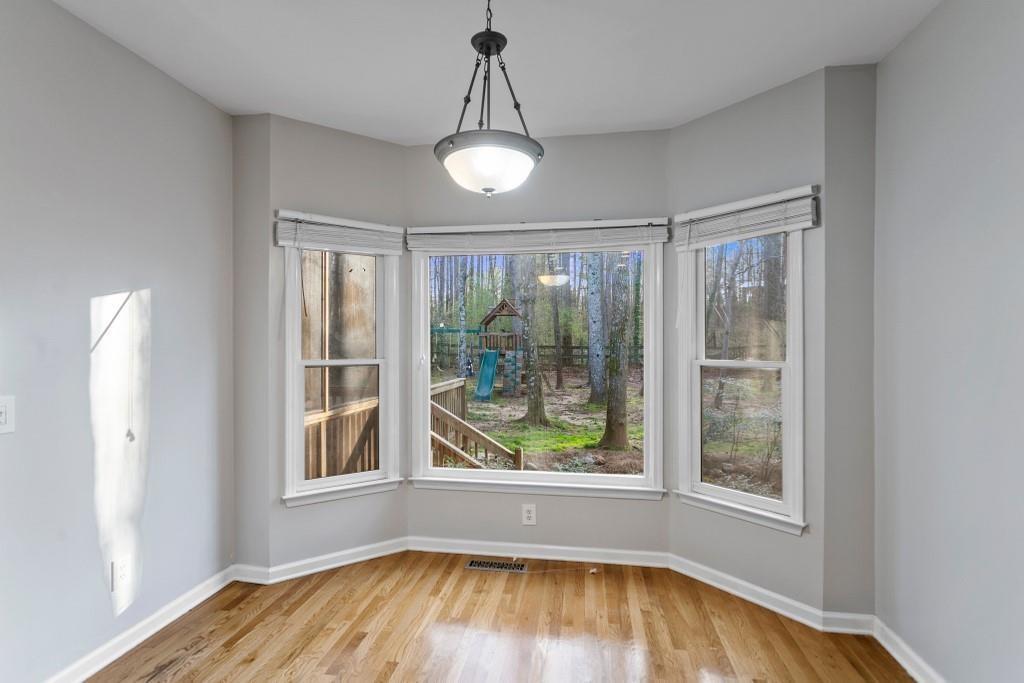 541 Battleview Drive Smyrna, GA 30082 - Photo 8 of 25 a view of an empty room with wooden floor and a window