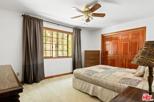 a bedroom with a large bed and a window