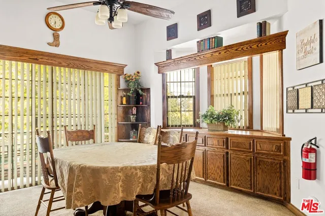 a view of a dining room with furniture and a large window