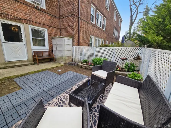 a view of a patio with table and chairs with wooden floor and fence