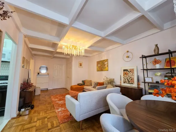 a living room with furniture and a chandelier