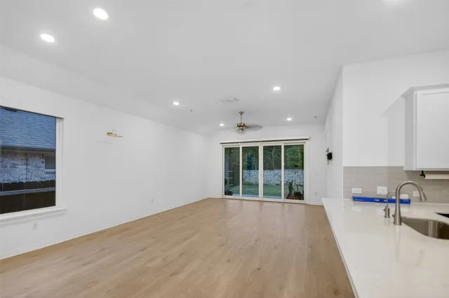 a view of a kitchen with large windows and a sink