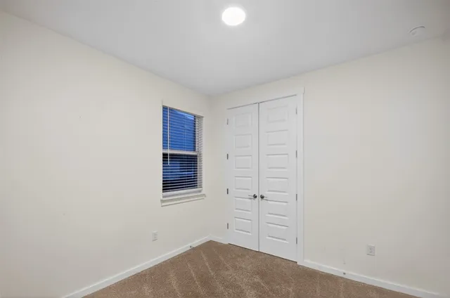 a bathroom with a toilet a sink a mirror a vanity and shower