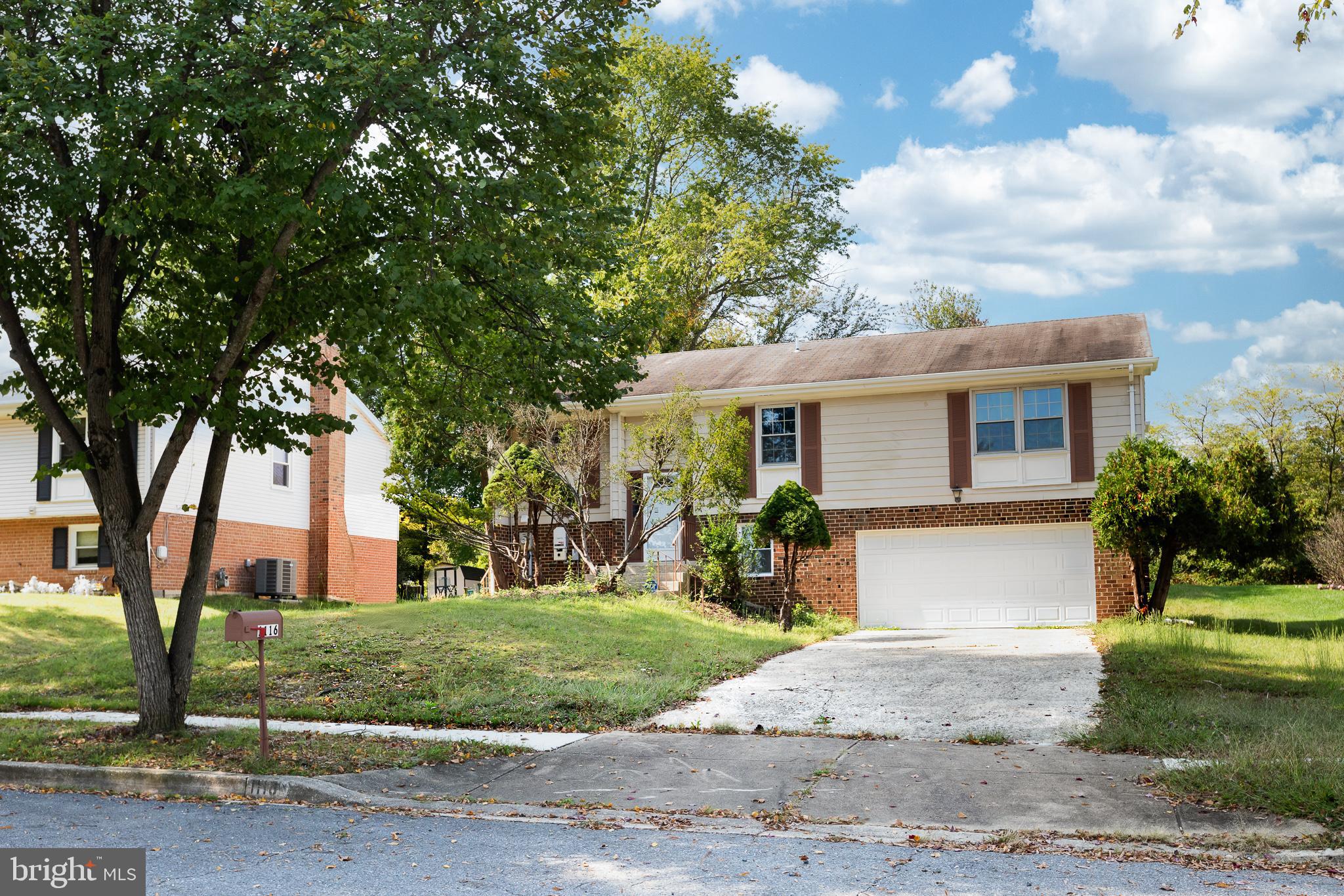 1116 Kings Tree Drive Bowie, MD 20721 - Photo 5 of 15 a front view of a house with a yard and potted plants