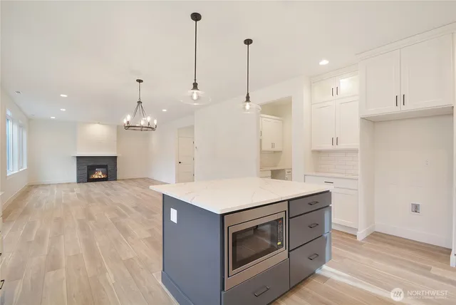 a kitchen with a stove sink and a wooden floor