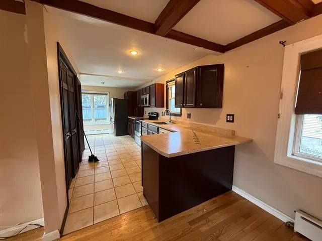 a kitchen with stainless steel appliances granite countertop a sink counter space and a window