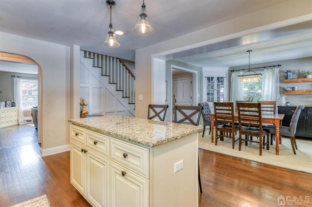 87 Chestnut Street Milltown, NJ 08850 - Photo 11 of 51 a view of living room kitchen island dining table and wooden floor