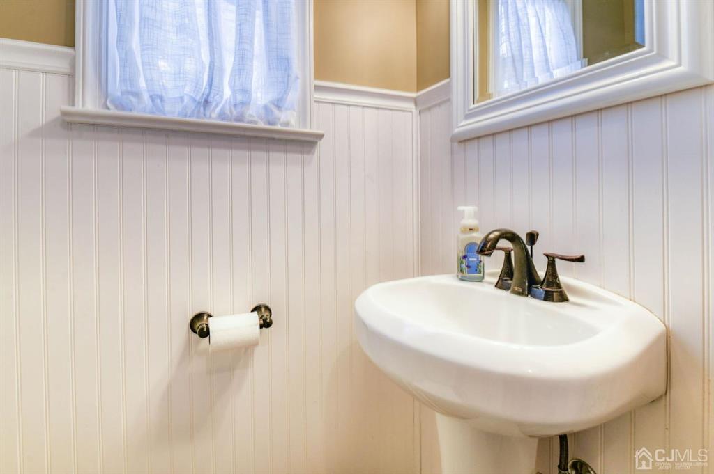 87 Chestnut Street Milltown, NJ 08850 - Photo 18 of 51 a bathroom with a sink a mirror and a window