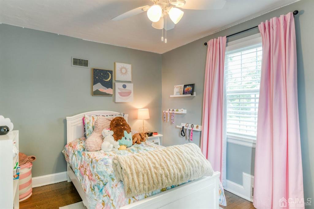 87 Chestnut Street Milltown, NJ 08850 - Photo 23 of 51 a bedroom with a bed and a chandelier