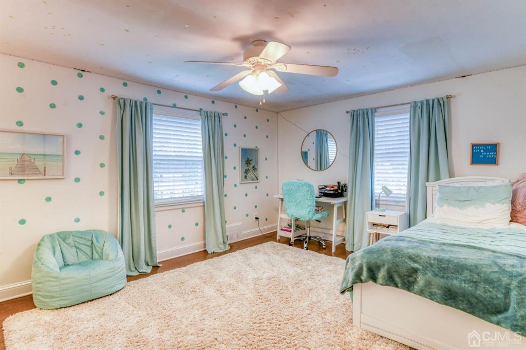 87 Chestnut Street Milltown, NJ 08850 - Photo 25 of 51 a bedroom with a balcony a bed and a chandelier
