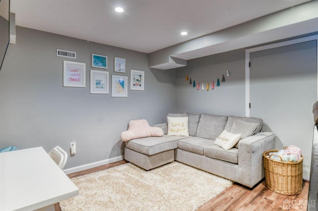87 Chestnut Street Milltown, NJ 08850 - Photo 27 of 51 a living room with furniture and a couch