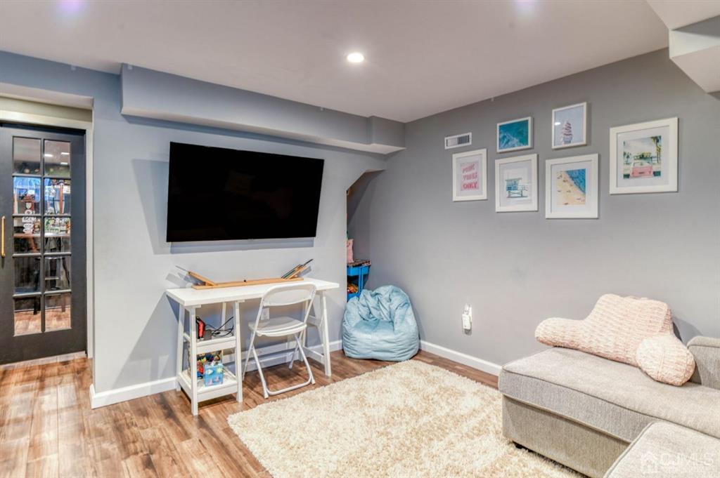 87 Chestnut Street Milltown, NJ 08850 - Photo 28 of 51 a living room with furniture and a flat screen tv