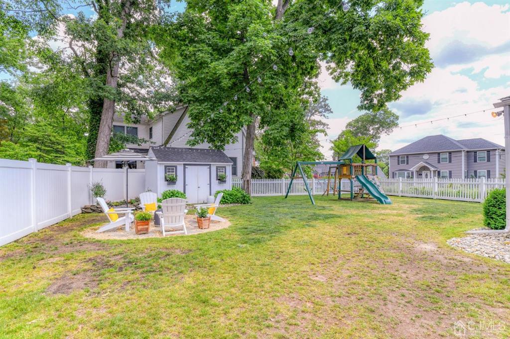 87 Chestnut Street Milltown, NJ 08850 - Photo 40 of 51 a backyard of a house with table and chairs