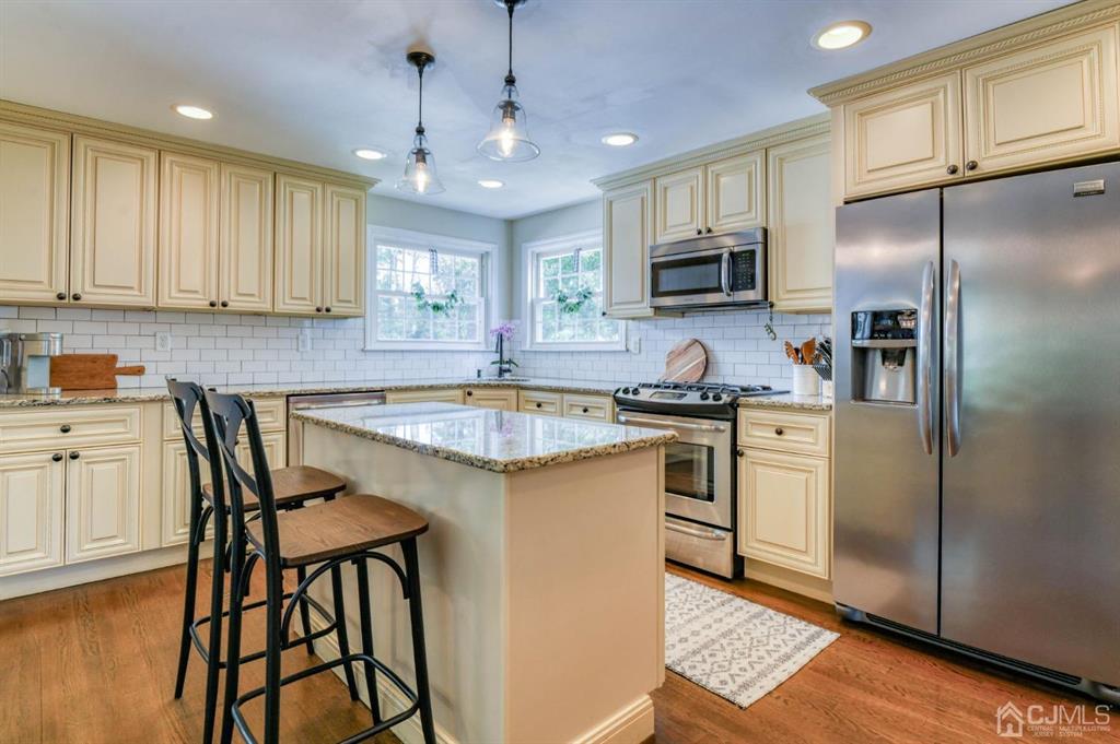 87 Chestnut Street Milltown, NJ 08850 - Photo 8 of 51 a kitchen with a sink stove and refrigerator
