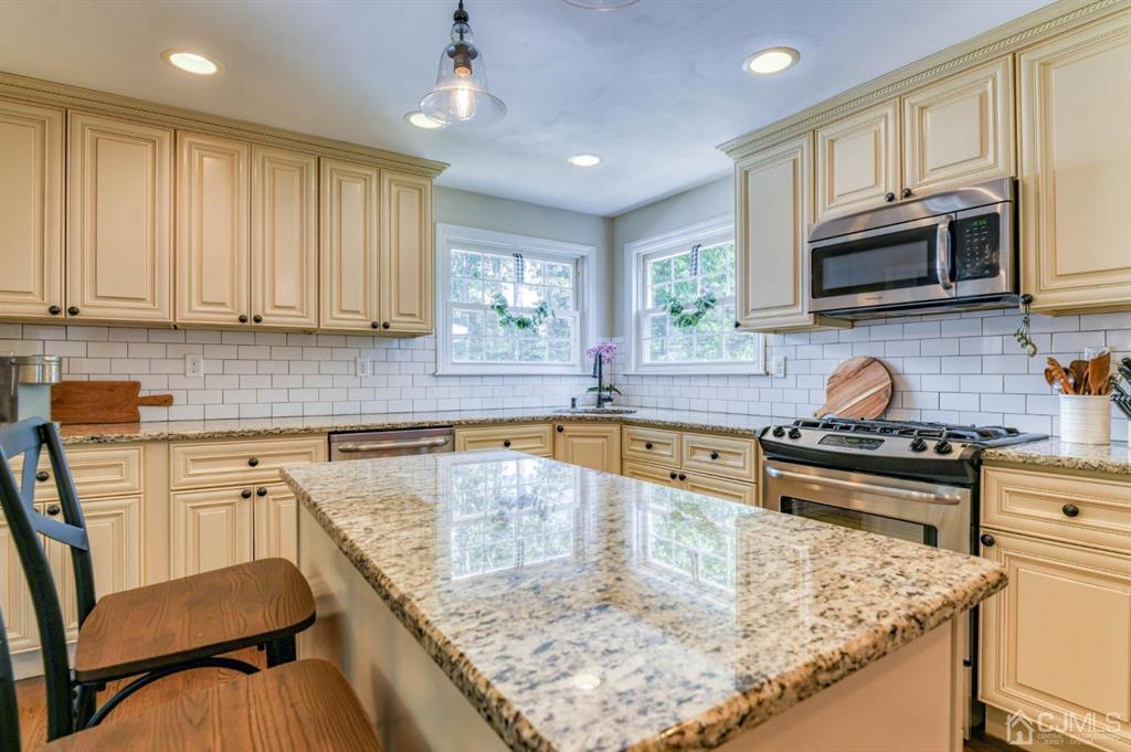 87 Chestnut Street Milltown, NJ 08850 - Photo 9 of 51 a kitchen with granite countertop a stove sink and microwave