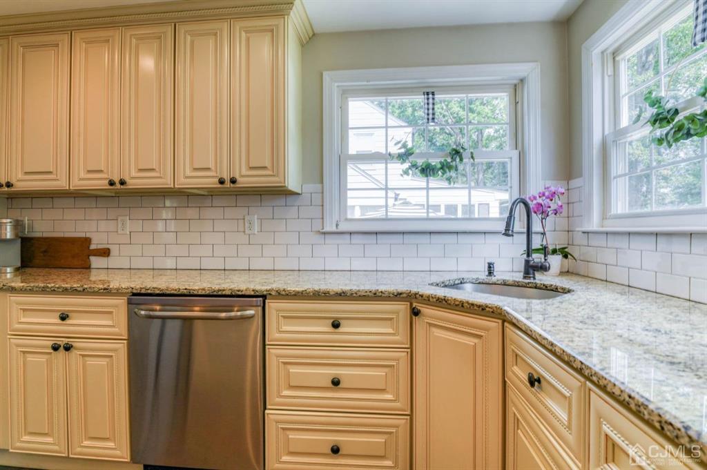 87 Chestnut Street Milltown, NJ 08850 - Photo 10 of 51 a kitchen with granite countertop a sink window and cabinets