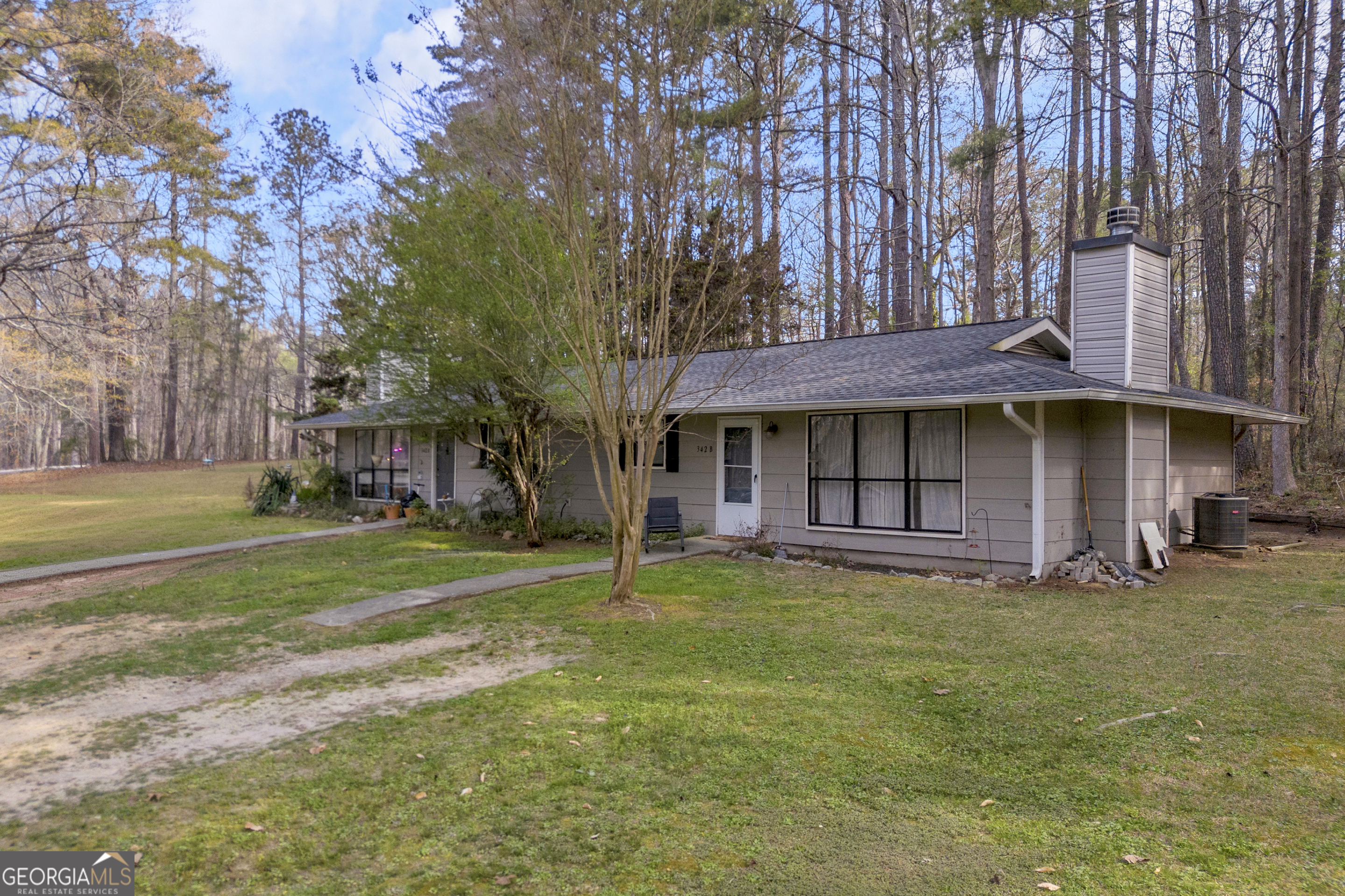 342 Brown Bridge Road Auburn, GA 30011 - Photo 18 of 74 a view of a large building with a big yard and large trees