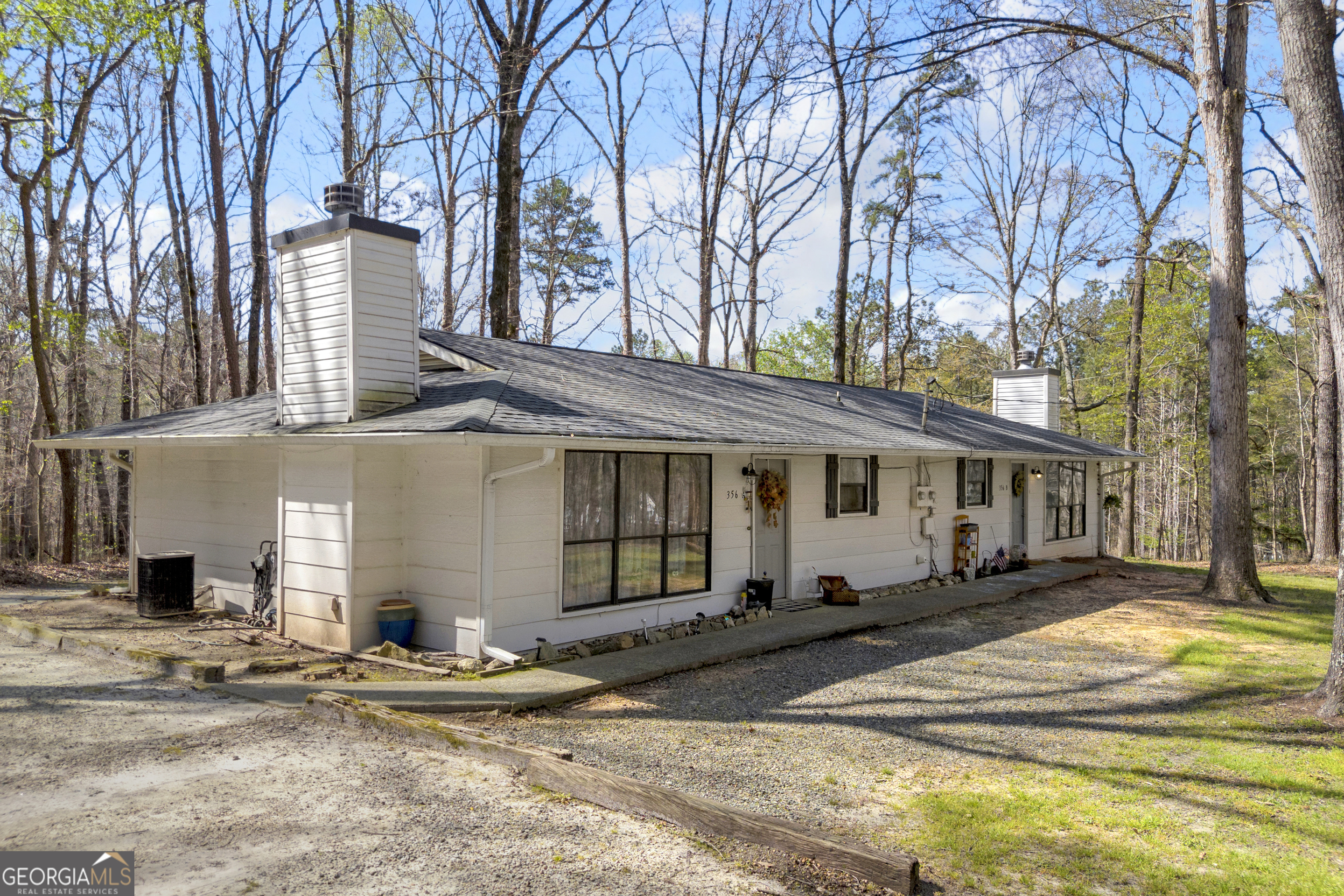 342 Brown Bridge Road Auburn, GA 30011 - Photo 25 of 74 a front view of a house with a yard and garage