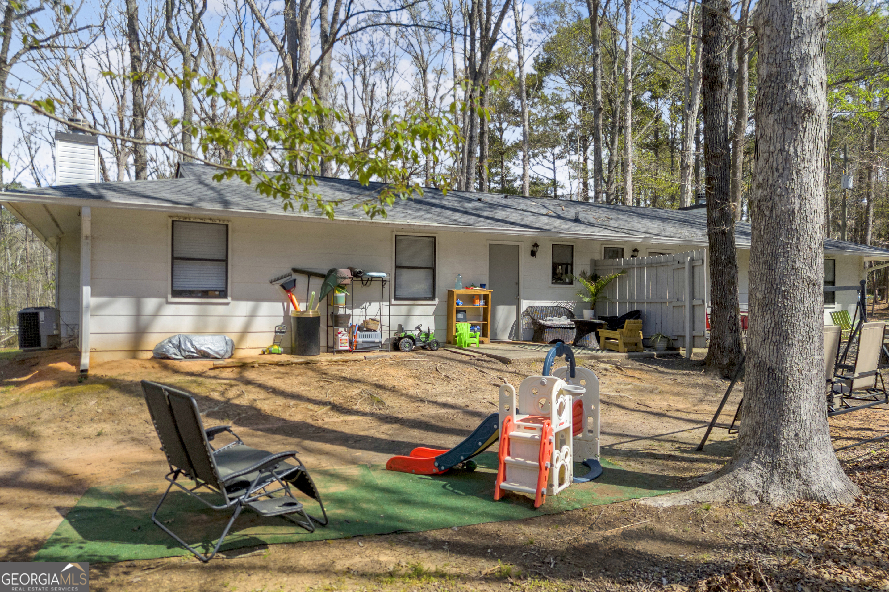 342 Brown Bridge Road Auburn, GA 30011 - Photo 29 of 74 a view of a backyard with chairs and a tree