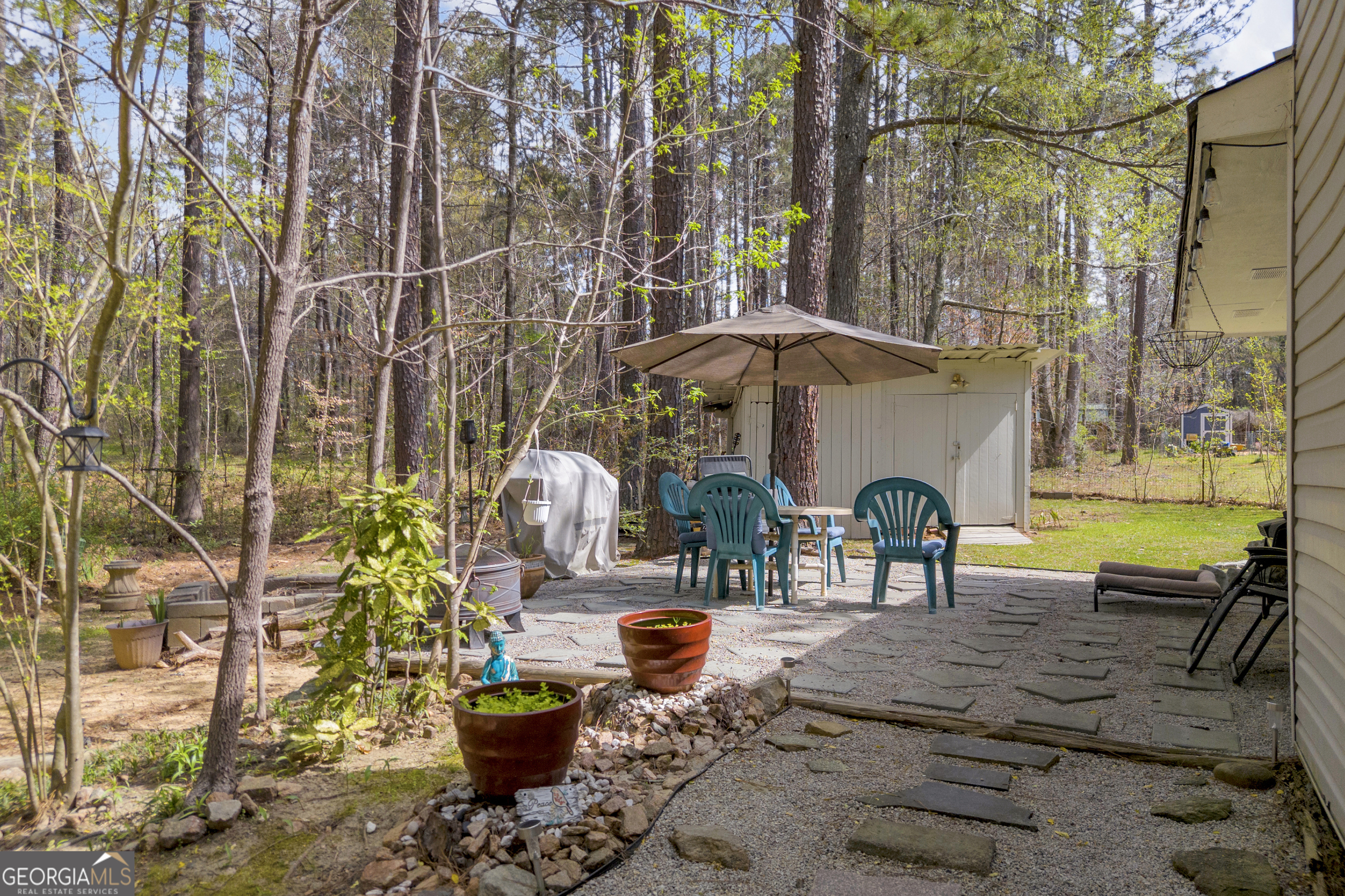 342 Brown Bridge Road Auburn, GA 30011 - Photo 41 of 74 a view of a patio with table and chairs potted plants