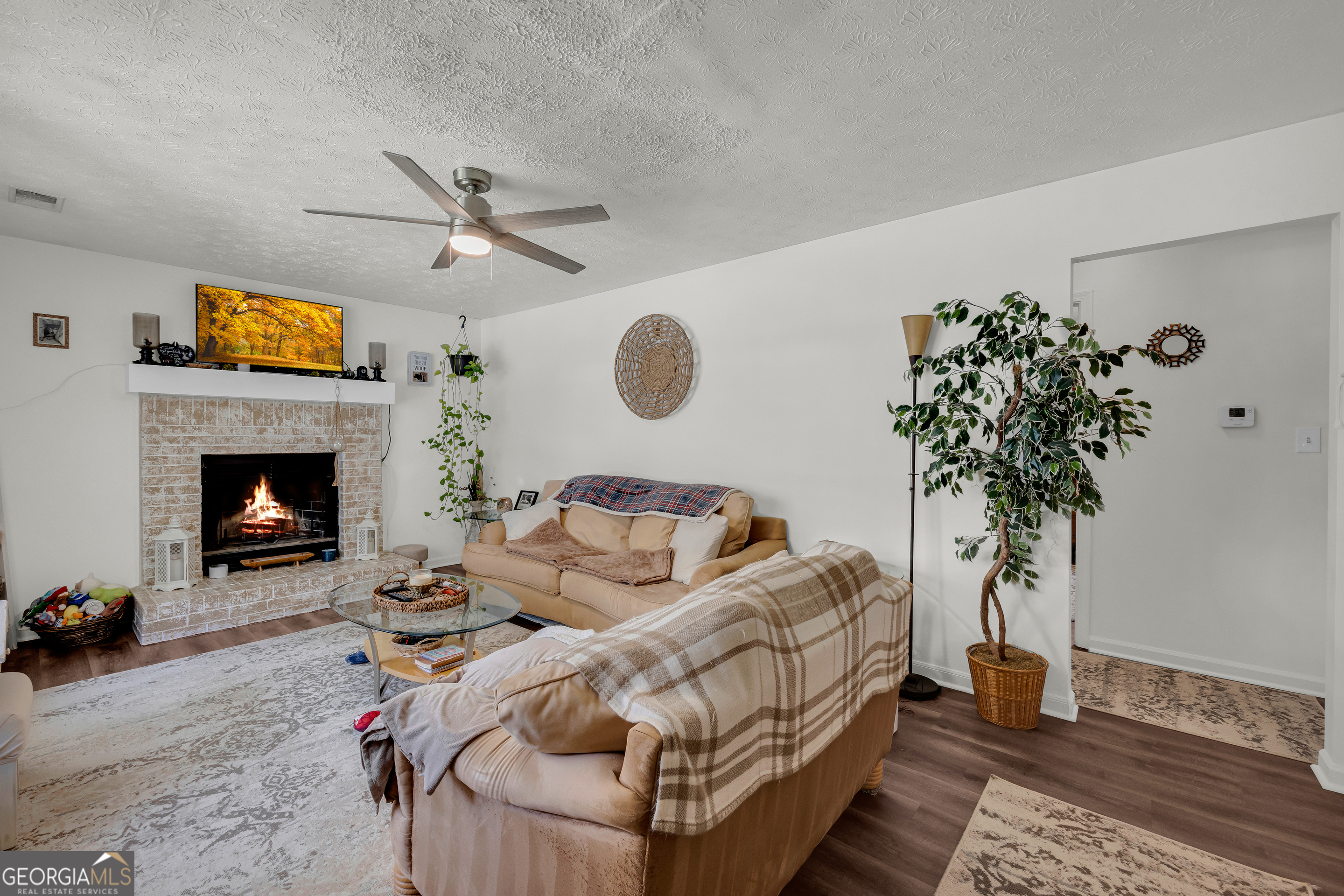 342 Brown Bridge Road Auburn, GA 30011 - Photo 63 of 74 a living room with furniture and a fireplace