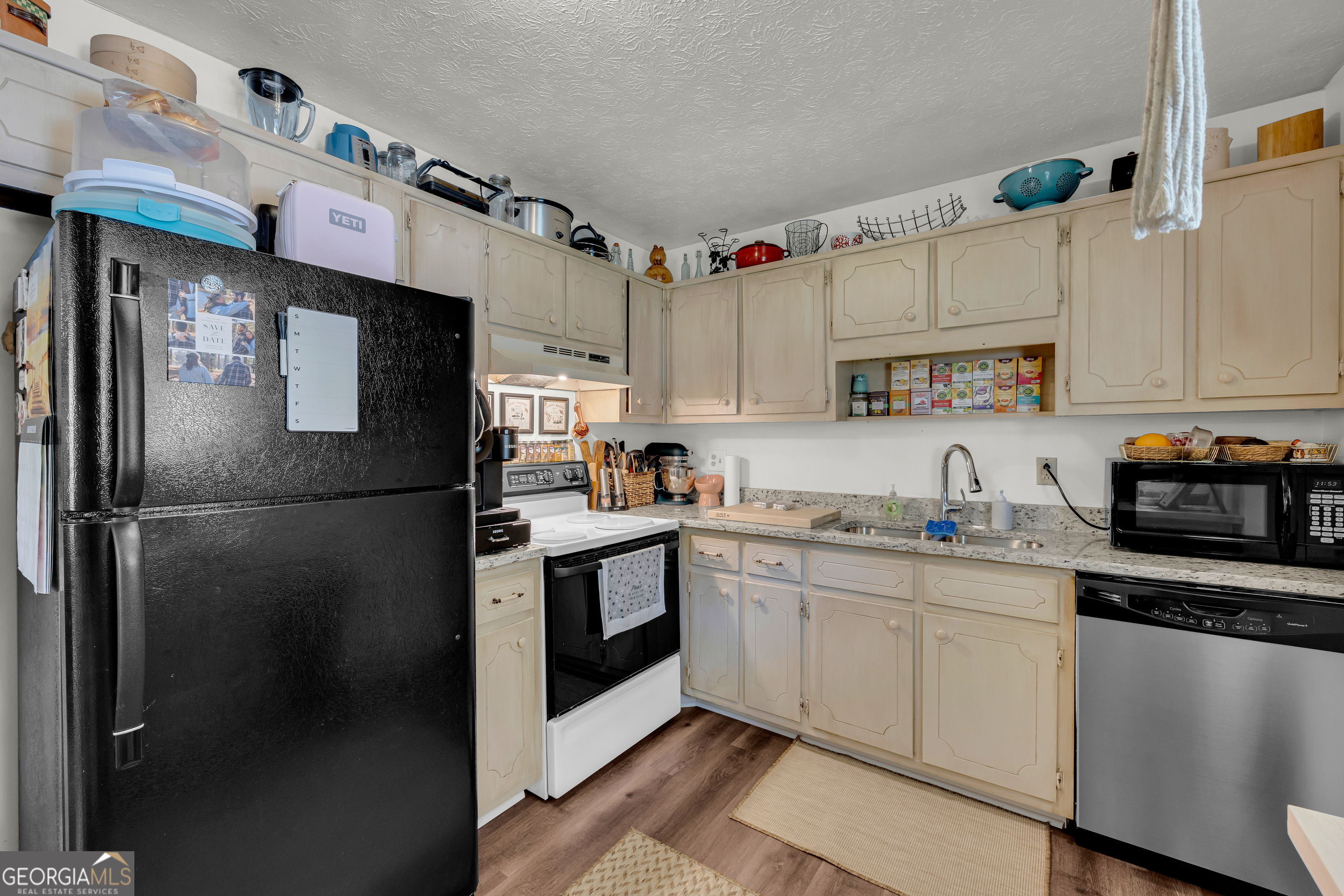 342 Brown Bridge Road Auburn, GA 30011 - Photo 67 of 74 a kitchen with stainless steel appliances granite countertop a refrigerator sink and cabinets