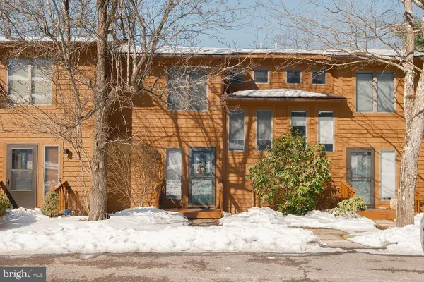 a view of a house with snow on the road