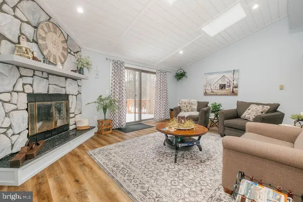 a living room with furniture a rug and a fireplace