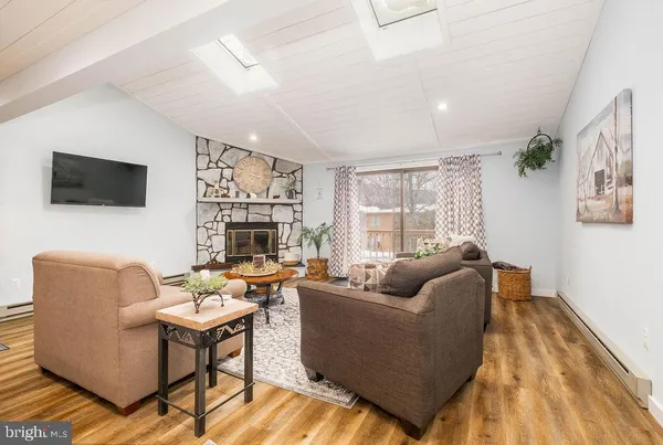 a living room with furniture fireplace and a flat screen tv