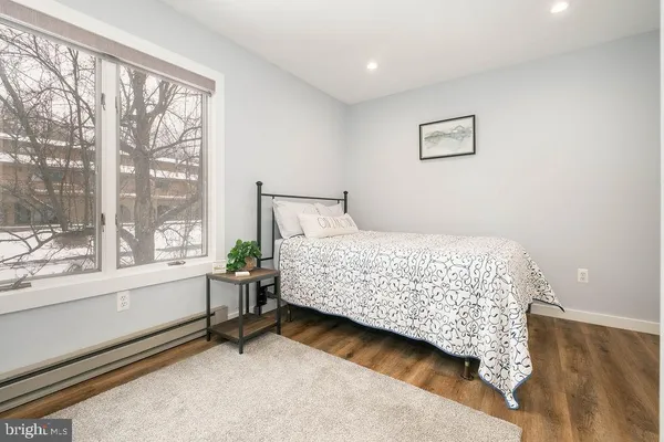 a bedroom with a large bed and a large window
