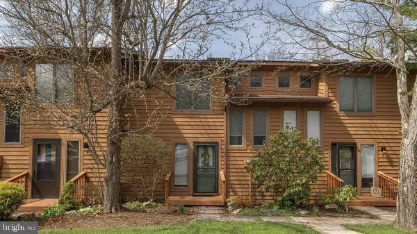 a large kitchen with stainless steel appliances granite countertop a stove oven a refrigerator a sink and a dining table with wooden floor