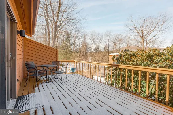 a balcony with wooden floor and fence